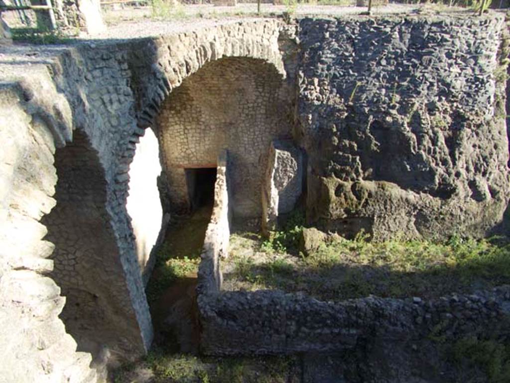III.1/2/18/19 Herculaneum, September 2015. Looking east from access bridge, with detail of lower rooms of Casa dell’Albergo. 
Looking towards doorway to corridor to upper floor, centre left, and room F, centre and right. Photo courtesy of Michael Binns.